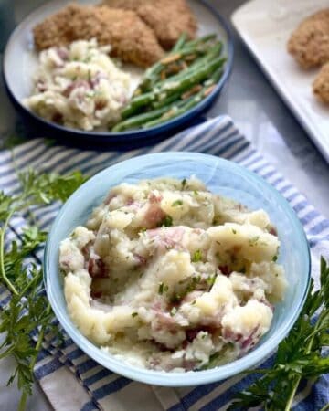 Potato and cauliflower mash in a blue serving dish