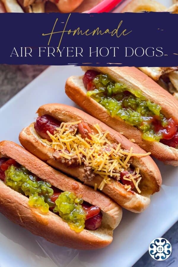 Three hot dogs on a platter with various toppings and a recipe title text on image for Pinterest.