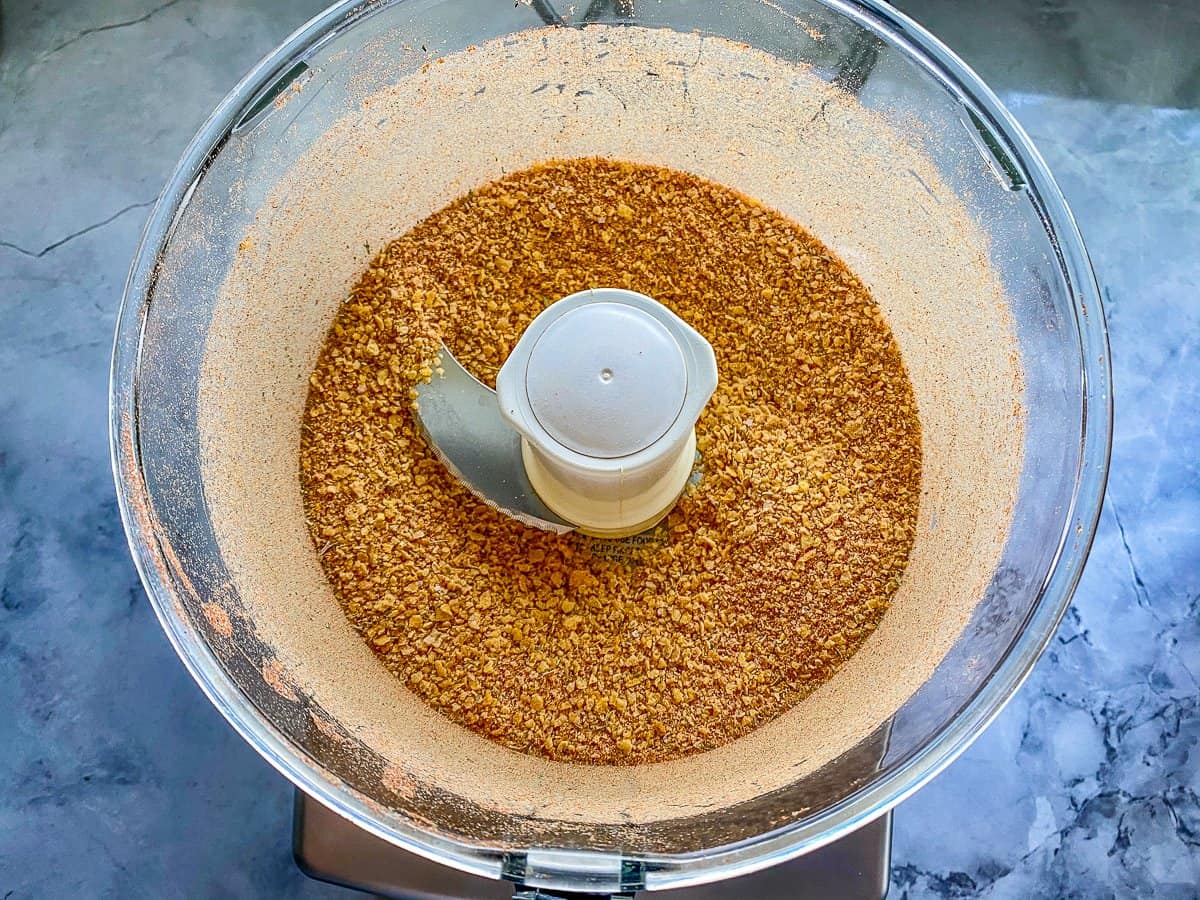 A clear bowl with grinder brown corn flakes.