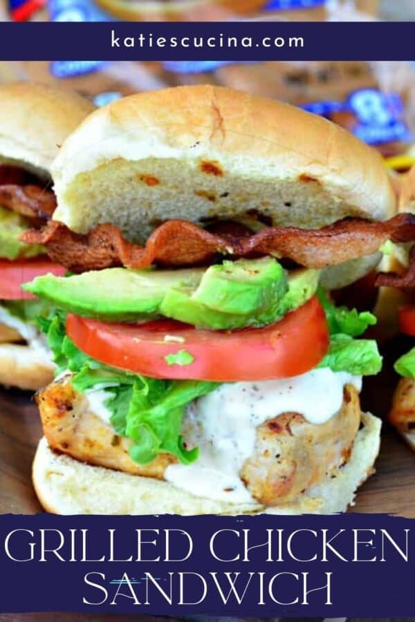 Grilled chicken sandwich with ranch dressing, lettuce, tomtao, avocado, and baon with reicpe title text on image for Pinterest.