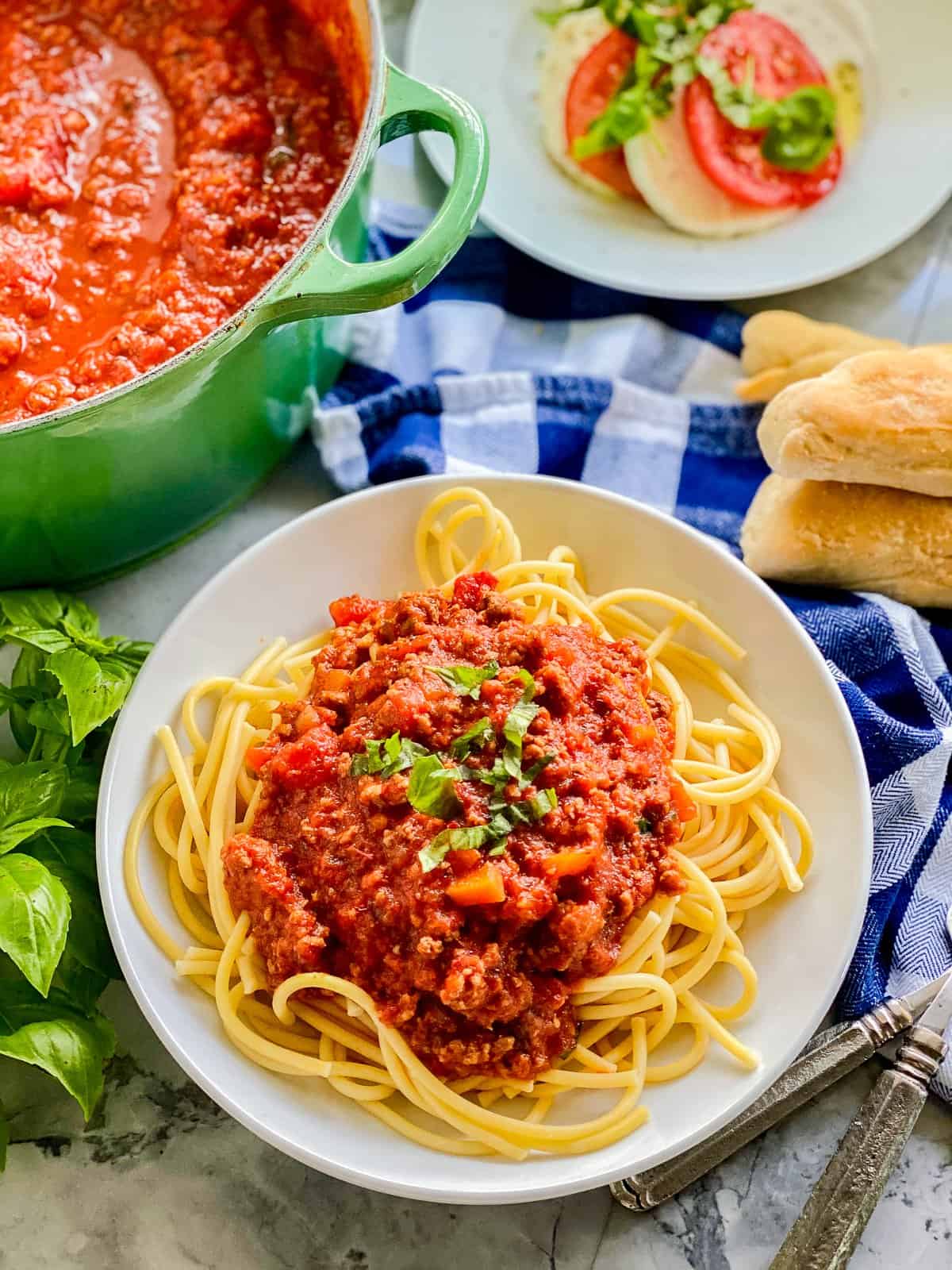 White bowl filled with pasta and meat sauce.