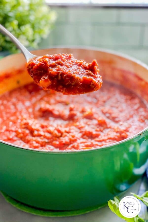 Green pot with red sauce.