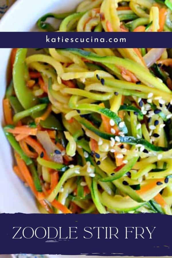 White bowl filled with spiralized zucchini noodles and juliene cararots with text on image for Pinterest.