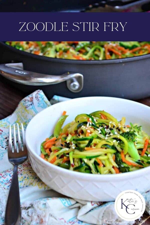 White bowl filled with zucchini noodles and veggies with text on image for Pinterest.
