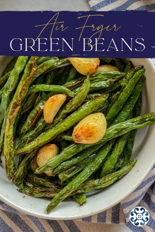 White bowl of green beans with garlic with blue banner on top
