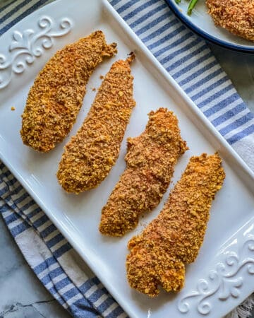 White plate with four chicken strips