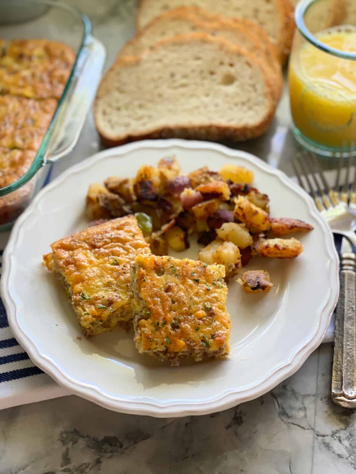 White plate with two square eggs slices with potatoes.