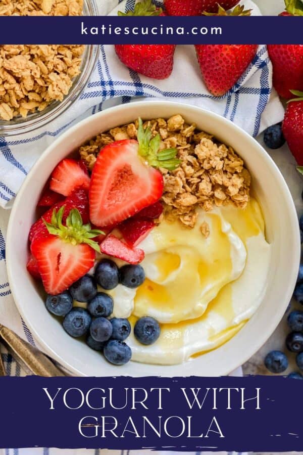 White bowl filled with yogurt, fruit, and granola with recipe title text on image for Pinterest.