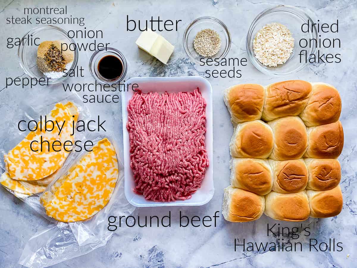 ingredients on counter; ground beef, rolls, seasonings, butter, cheese, sesame seeds, and worchestire sauce.