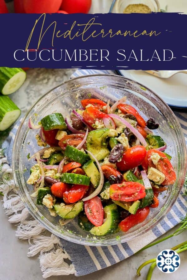 Glass bowl with cucumber, tomato, onion with recipe title text on image for Pinterest.