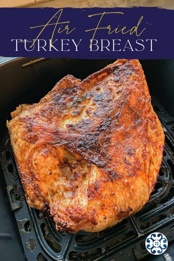 Cooked half turkey breast in an Air Fryer basket with recipe title text on iamge for Pinterest.