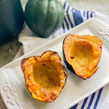 White platter with cooked acorn squash.