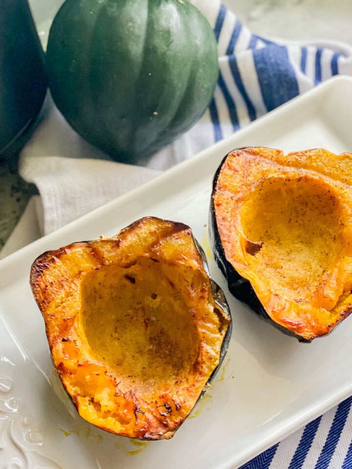 White platter with cooked acorn squash.