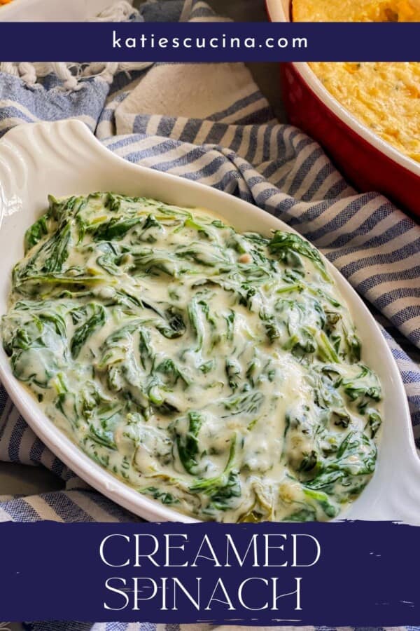 White oval dish filled with spinach with recipe title text on image for Pinterest.