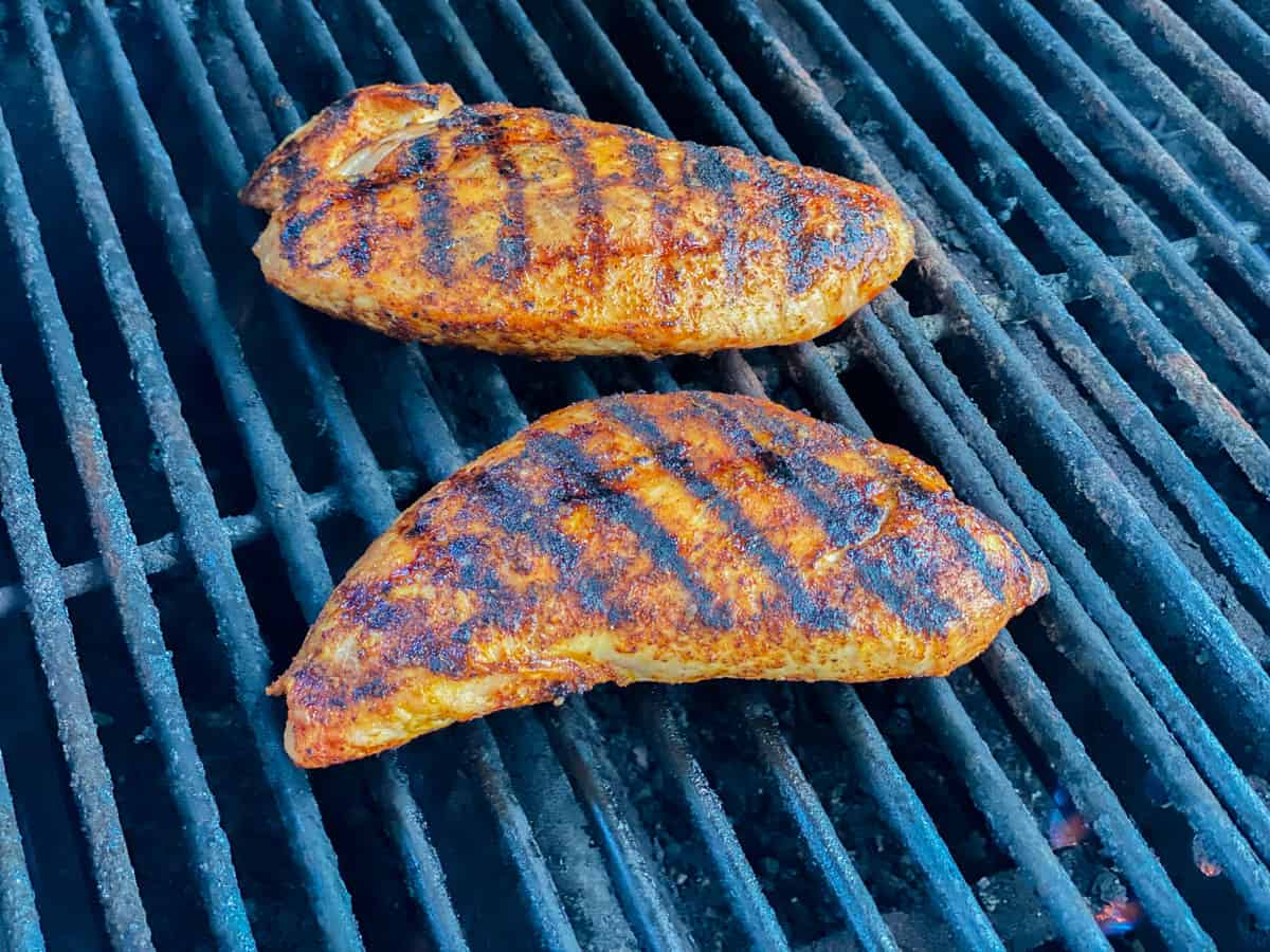 Two turkey tenderloins on a grill.