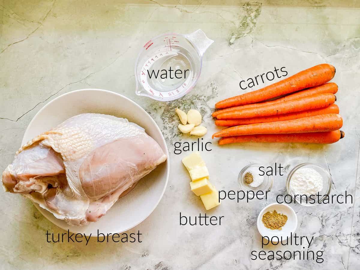 Ingredients on counter; turkey breast, carrots, garlic, salt, pepper, poultry seasoning, butter, water, and cornstarch.