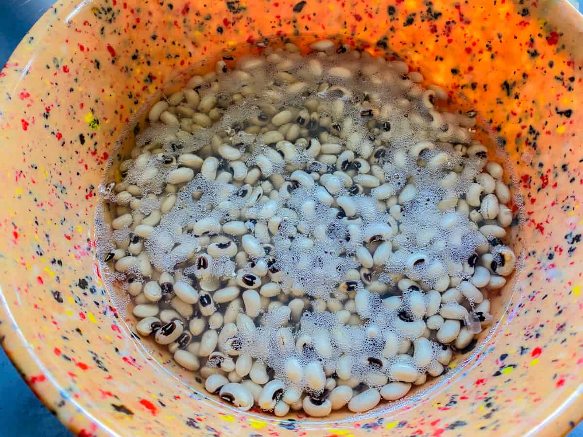 Orange speckled bow filled with water and black eyed peas.