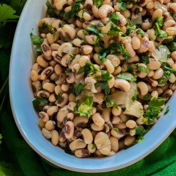White oval dish filled with black eyed peas.