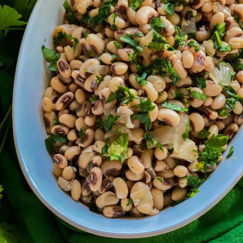 White oval dish filled with black eyed peas.