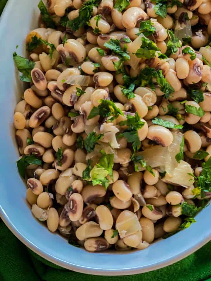 White oval dish filled with black eyed peas.