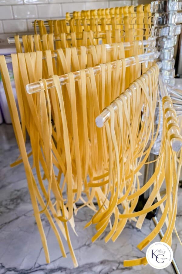 Pasta drying rack with fresh linguine resting on top.
