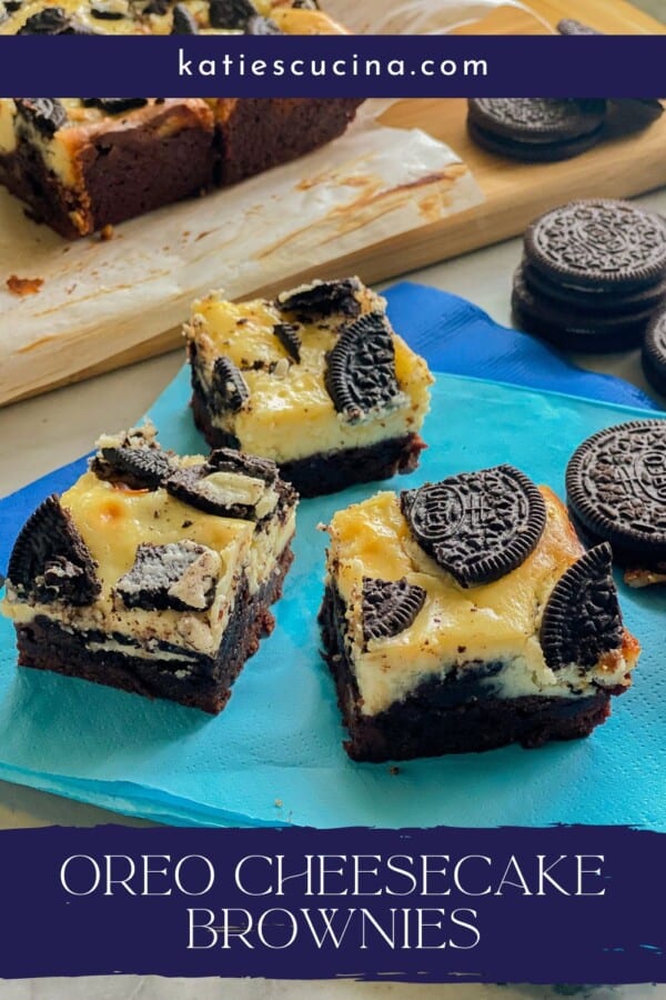 Three slices of brownies topped with cheesecakes and oreos on a bright blue napkin with recipe title text on image.