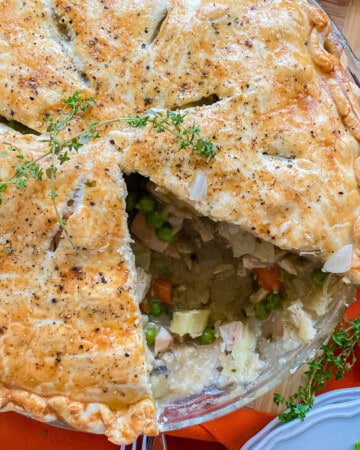 Close up of a turkey pot pie with a slice taken out of it.