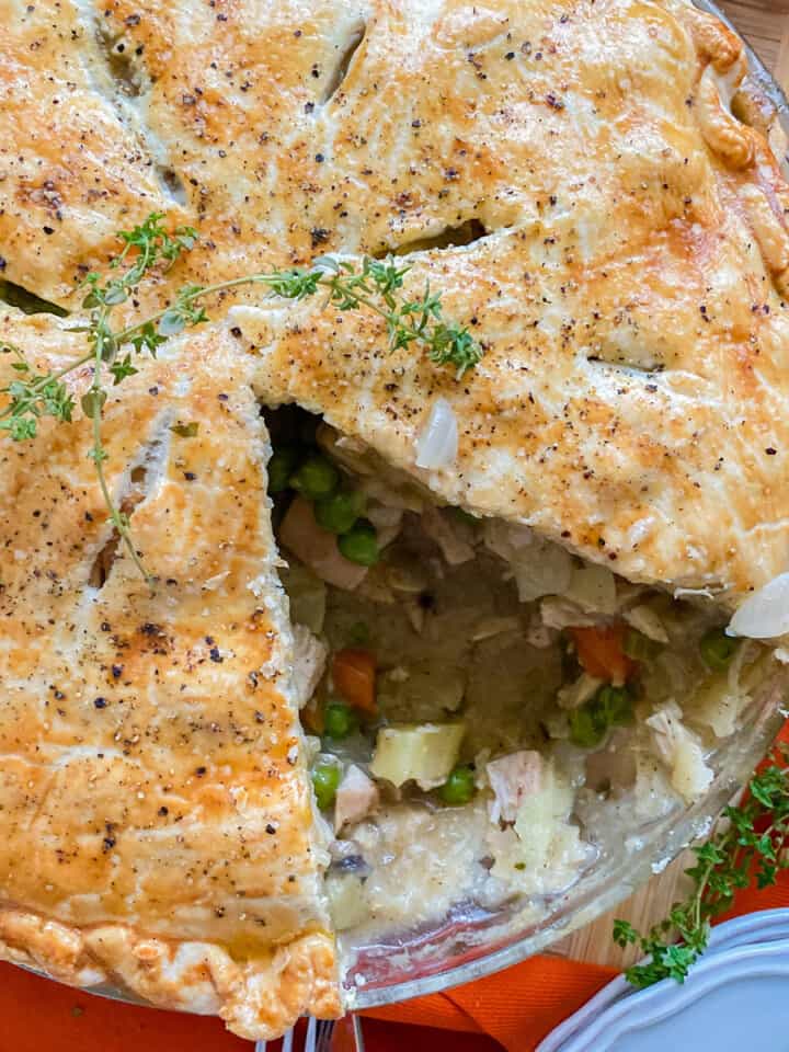 Close up of a turkey pot pie with a slice taken out of it.