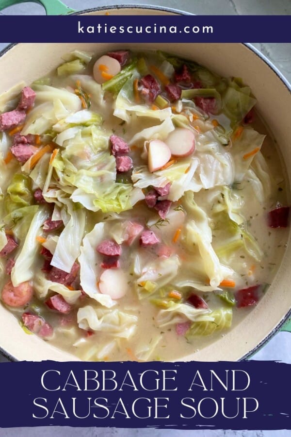 Green pot filled with broth, cabbage, sausage, and potatoes with recipe title text on image for Pinterest.