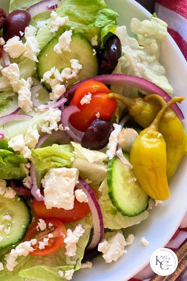 Close up of greek salad with a logo on the right corner.