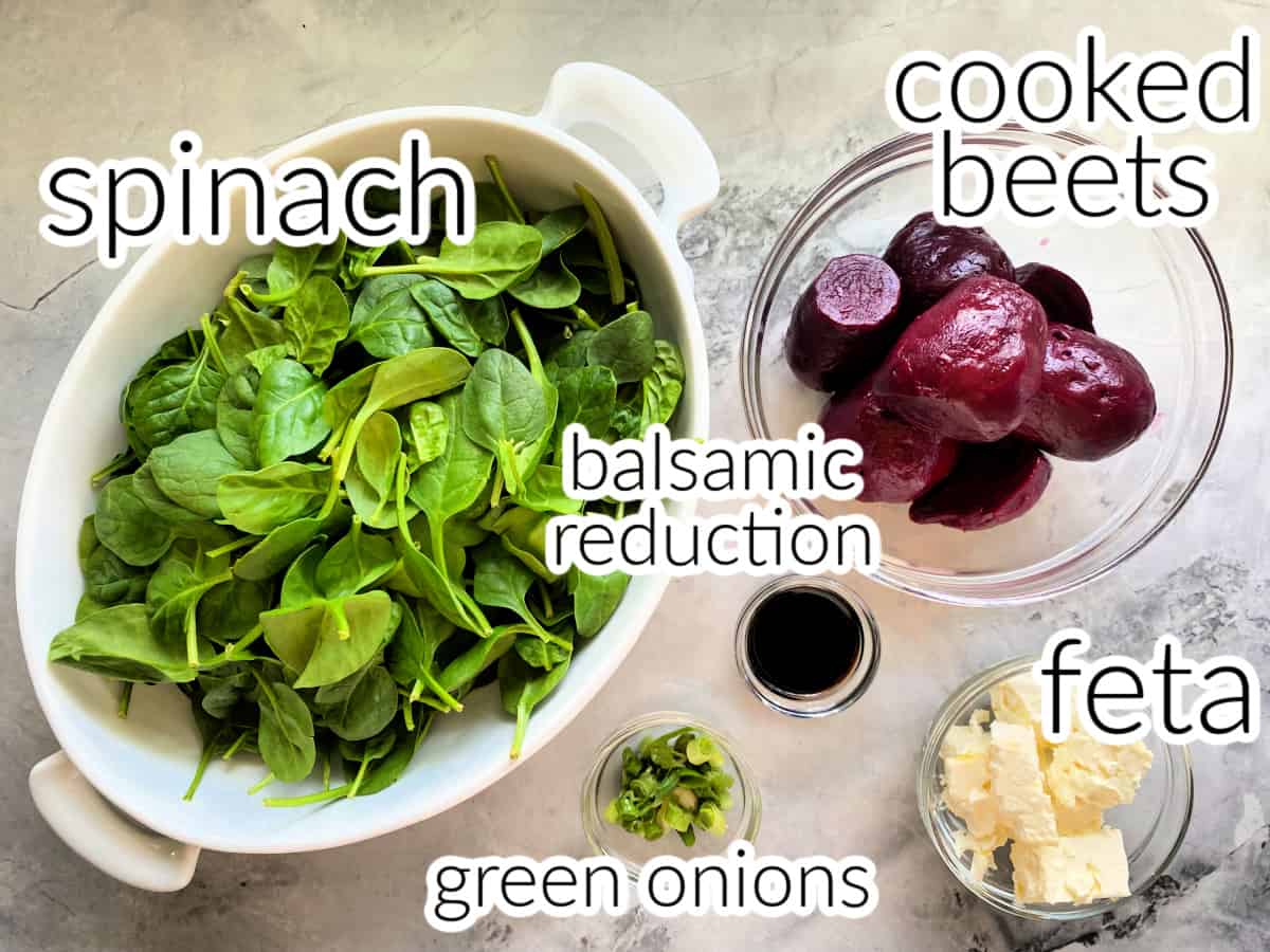 Ingredients on counter: spinach, balsamic reduction, cooked beets, feta, and green onions.