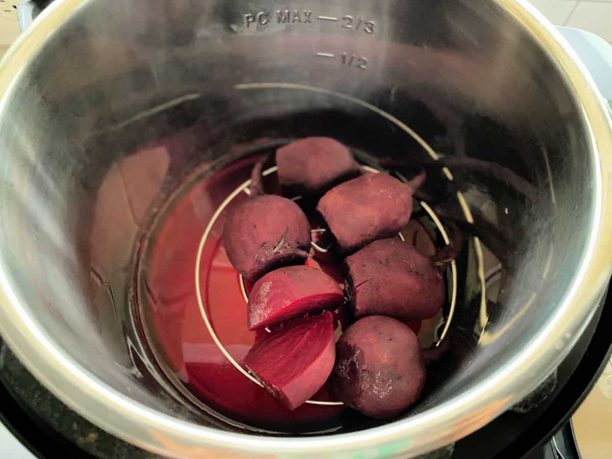 Six cooked beets in an Instant Pot.