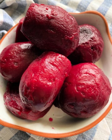 White bowl filled with cooked beets.