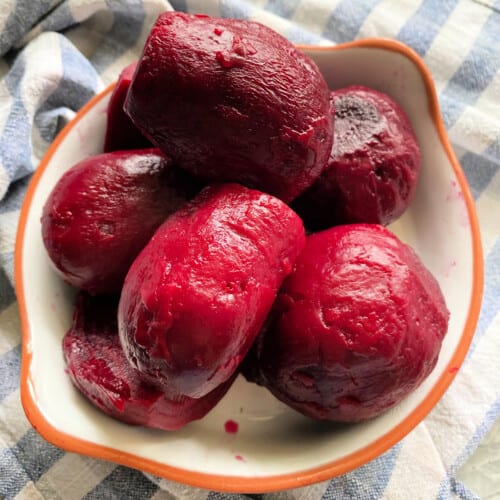White bowl filled with cooked beets.