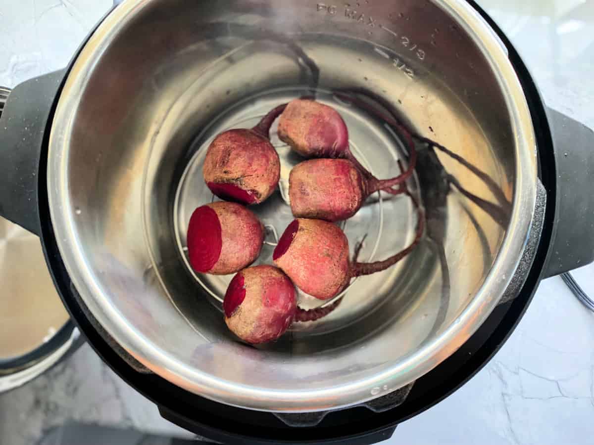 Instant Pot filled with raw beets and water.