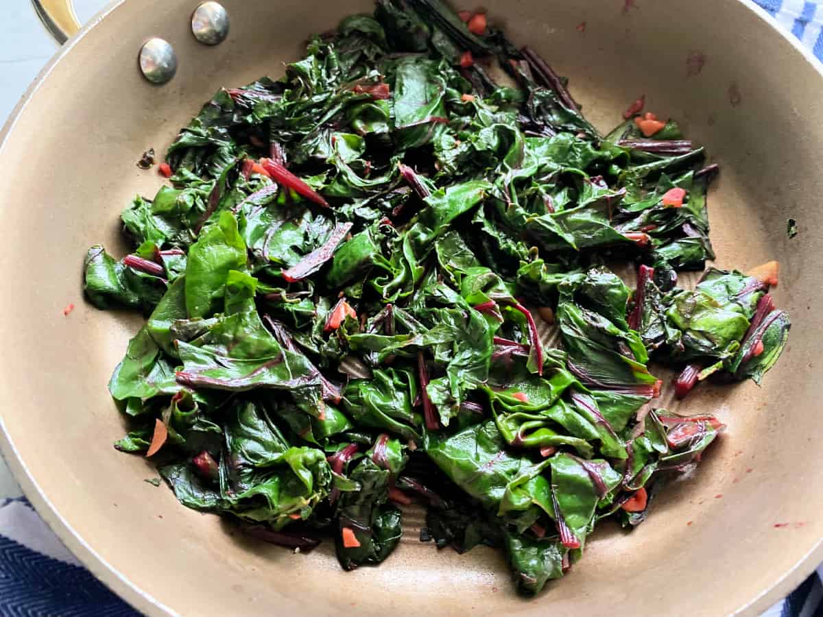 Sauteed greens in a brown skillet.