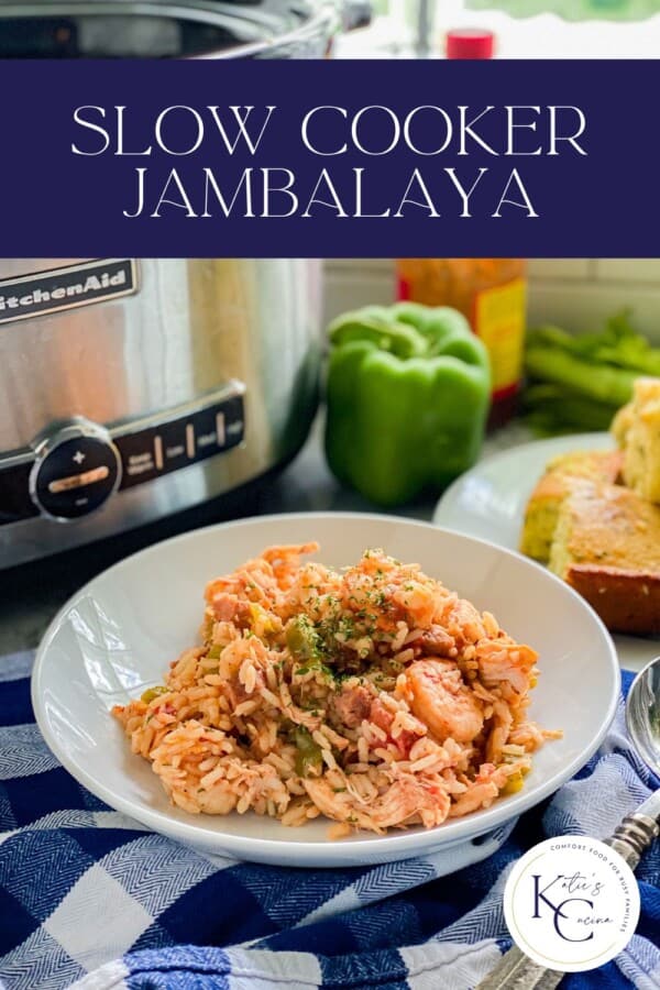 White bowl filled with rice, shrimp, and chicken with a silver slow cooker in the background and recipe title text on image for pinterest.