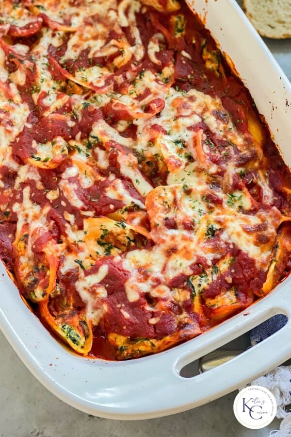 Stuffed Shells Baked in a white baking dish.