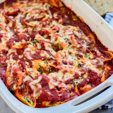 Up Close photo of the Spinach Stuffed Shells laying in a white baking dish.