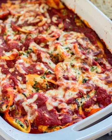 Up Close photo of the Spinach Stuffed Shells laying in a white baking dish.