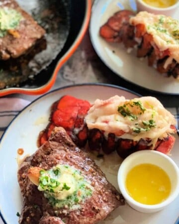 Two round white plates with lobster tails, steak, and butter with logo on right corner.