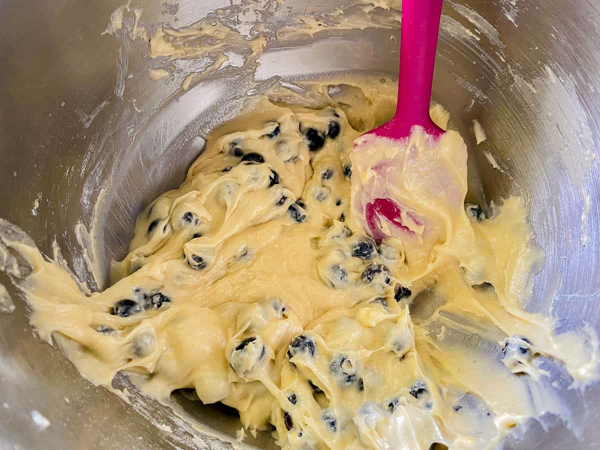 Blueberry muffin mix being mixed together in a bowl.