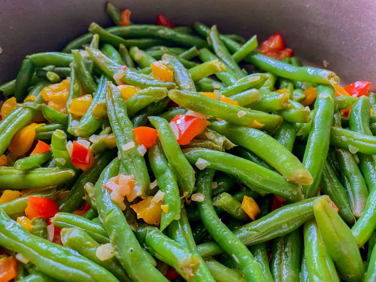 Green beans being cooked in a skillet.