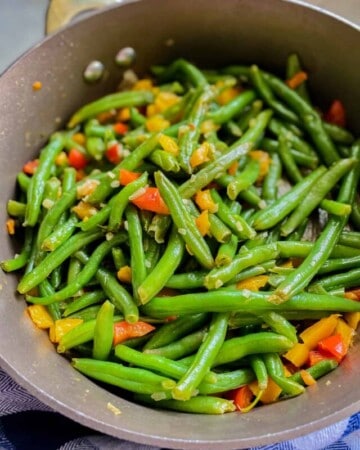 Cooked green beans in a skillet.