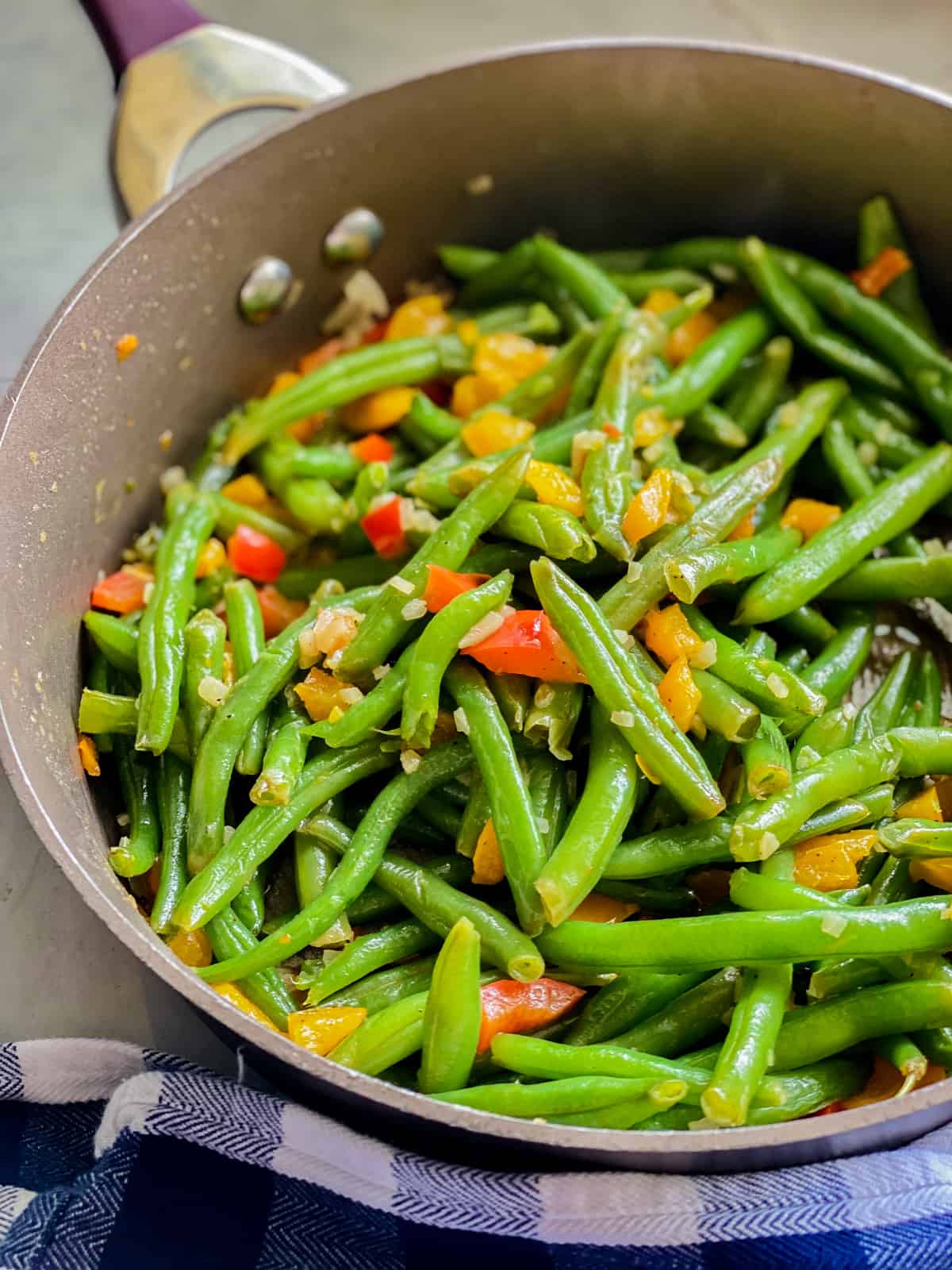 Cooked green beans in a skillet.