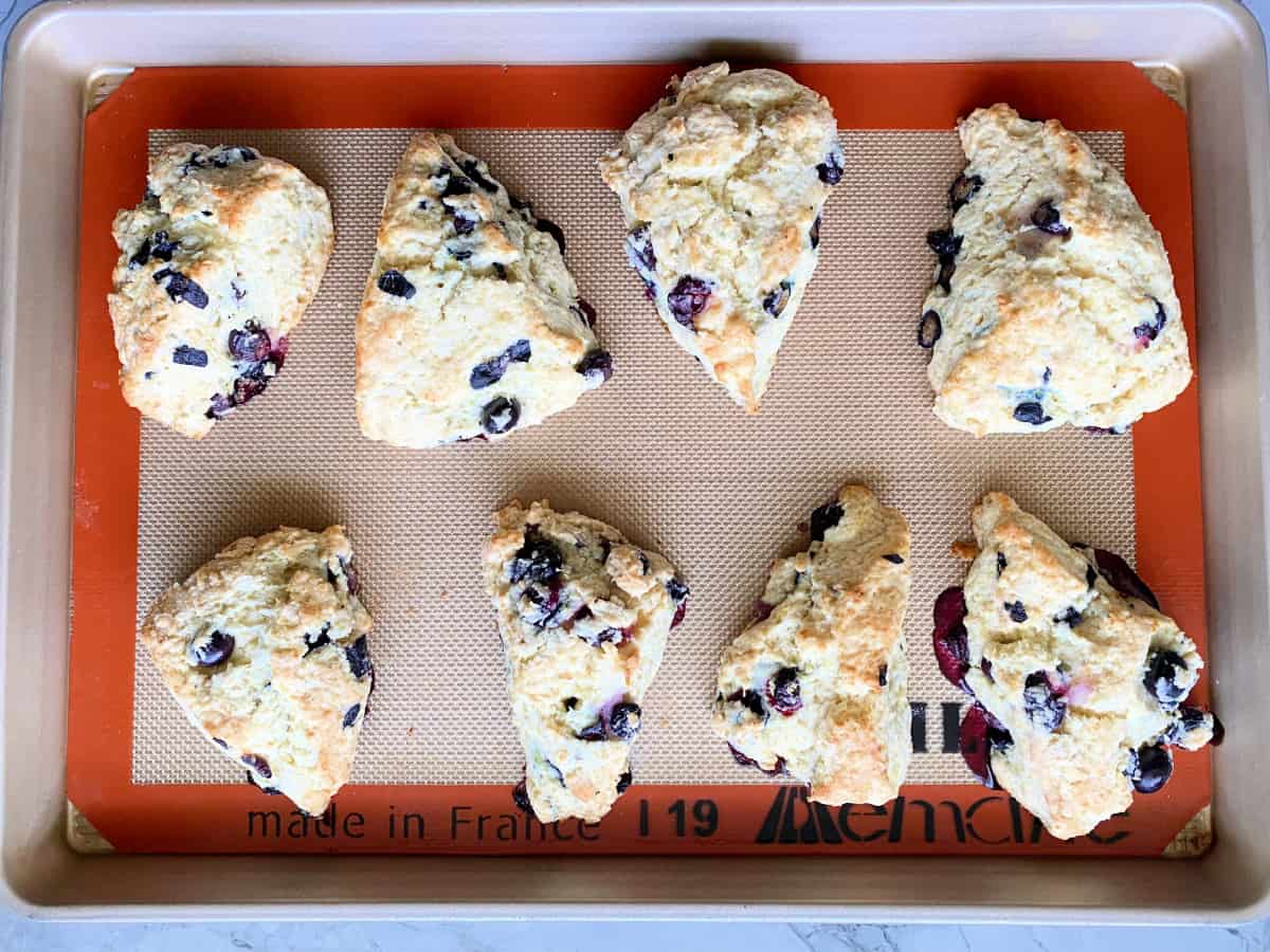 Baking tray with eight scones baked on top.