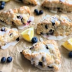 6 scones on brown paper with glaze on top.