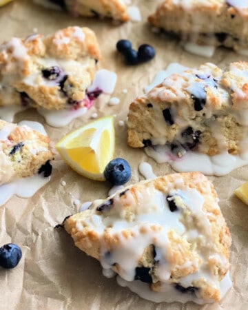 6 scones on brown paper with glaze on top.