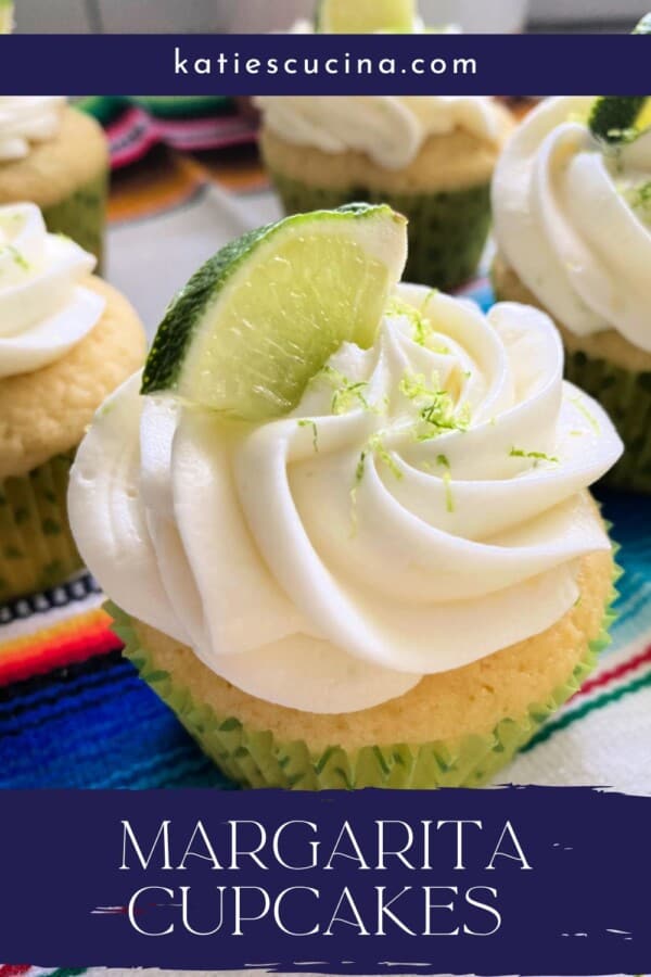 Four white cupcakes with white frosting and lime zest and lime on top in a green polka dot wrapper with recipe title text on image for Pinterest.