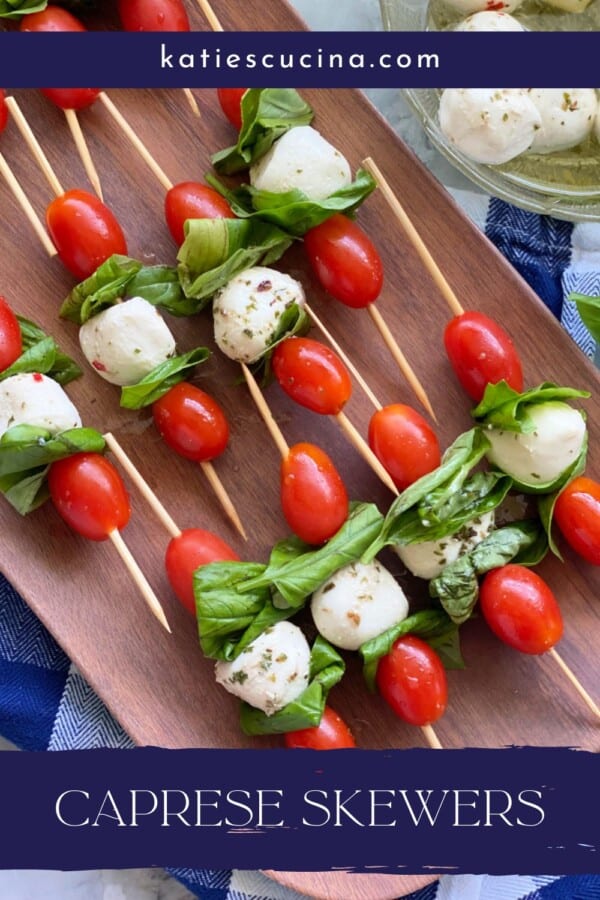 Brown platter filled with Caprese Skewers with recipe title text on image for Pinterest.